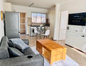 a living room with a couch and a coffee table at One bedroom cosy apartment in Kempton Park in Kempton Park