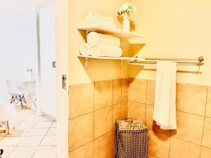 a bathroom with a towel rack and towels at One bedroom cosy apartment in Kempton Park in Kempton Park