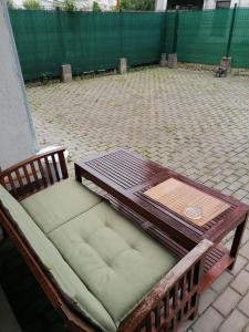 a bench with a table and a coffee table at Queency Apartament cu gradina și parcare gratuita in Cluj-Napoca