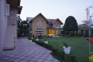 una casa con césped y acera en Farsal Villa, en Srinagar