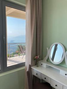a bathroom with a mirror and a desk with a window at Villa Eagle Eye Montenegro in Kotor