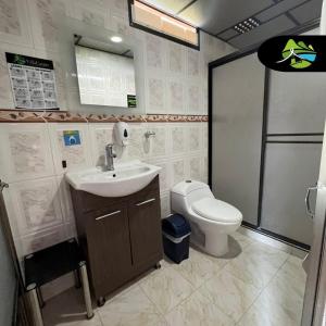 a bathroom with a sink and a toilet at Finca Campestre Villa del Campo in Santa Rosa de Cabal