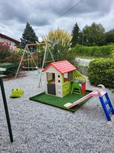 a small playground with a slide and a swing at Maithagarria in Aicirits