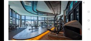 a fitness room with a gym with a treadmill at Geo Condo Homestay Kota Kemuning Bukit Rimau in Shah Alam