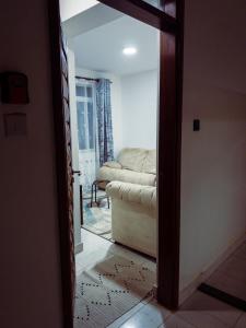 una puerta que conduce a una sala de estar con sofá en Greenzone Luxury 1 Bed Apartment, en Nairobi