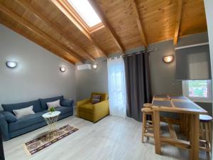 a living room with a blue couch and a table at Villa Yseni in Orikum