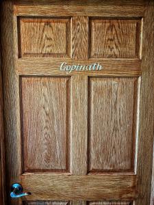 a wooden door with the word copeland written on it at Giriraja Ashraya in Moundsville +5 photos