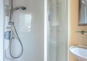 a bathroom with a shower and a sink at B12, Tal y Fan in Abersoch