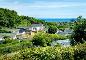 a town with houses and the ocean in the background at B12, Tal y Fan in Abersoch