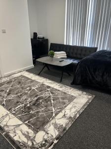 a living room with a couch and a table at Deluxe En-Suite Bedroom In the Centre of Watford in Watford