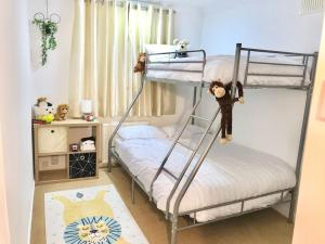 a bedroom with two bunk beds in a room at Dolphin Retreat close to Beaches and Harbour in Poole