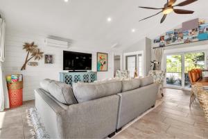 a living room with a couch and a tv at Awesome Location with Dock, Pool, Bicycles & Kayaks in Cape Coral