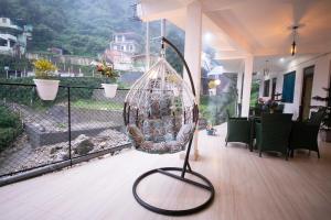 a bird cage sitting on the floor of a balcony at PerfectStayz Mussoorie Hills in Mussoorie