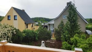 a house with a yard with trees and a fence at Haus Seefeld in Ueckeritz