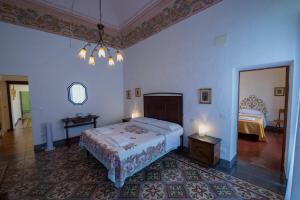 a bedroom with a bed and a table and a mirror at Palazzo De Luigi in Volterra