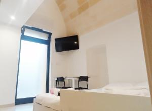 a room with a bed and a table with two chairs at STRADONE 132 in Gravina in Puglia