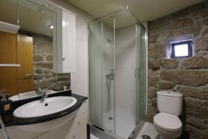 a bathroom with a sink and a toilet and a shower at Casa da Cascata in Pincães +12 photos