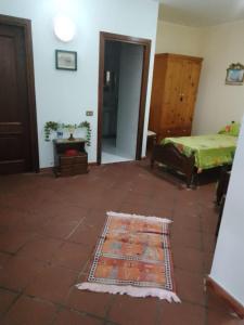 a room with a bed and a rug on the floor at Casa Vacanze Baia Verde in Trabia