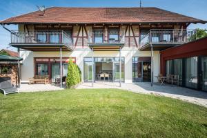 a house with a lawn in front of it at Landhotel und Gasthof Hirsch Hüttenreute in Hoßkirch