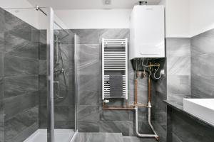a bathroom with a shower and a sink at WSP Petrin Garden Apartments in Prague +77 photos