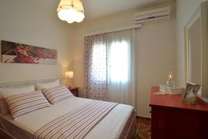 a bedroom with a large bed and a window at Villa Gaia in Dassia +11 photos