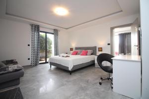 a bedroom with a bed and a desk and a chair at Apartments Toni in Primošten