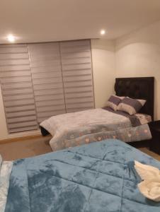 Кровать или кровати в номере Hermoso departamento en La Paz-Bolivia
