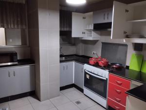 cocina con armarios blancos y fogones en Hermoso departamento en La Paz-Bolivia en La Paz