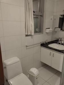 a white bathroom with a toilet and a sink at Hermoso departamento en La Paz-Bolivia in La Paz