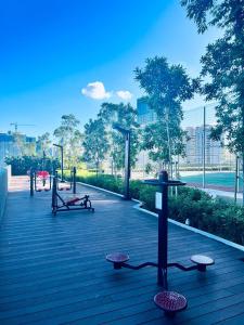 a park with benches and picnic tables and trees at Sentral Serviced Suites Kuala Lumpur in Kuala Lumpur