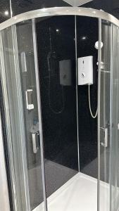 a shower with a glass enclosure in a bathroom at Aaran Central Guesthouse in Aberdeen
