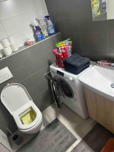 a bathroom with a toilet and a sink at Bratislava Centrum, Ahoj park apartments, 6floor with balcony in Koliba