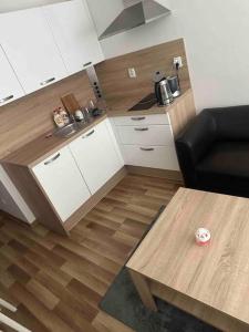 a kitchen with a couch and a table in a room at Bratislava Centrum, Ahoj park apartments, 6floor with balcony in Koliba