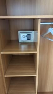 a small microwave sitting on top of a shelf at DOWNTOWN Fiume, underground Garage within the property in Rijeka