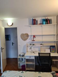 a room with a desk and shelves and a bed at CHAMBRE DE 11 M2 AVEC BALCON in Paris