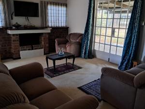 a living room with a couch and a coffee table at KASP Cottage in Underberg