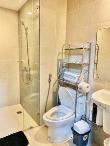 a bathroom with a shower and a toilet and a sink at Homey-feel Studio Unit @ Lafayette Park Square Condominium in Iloilo City