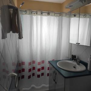 a bathroom with a shower curtain and a sink at CASA ROSAMAR in Agulo