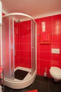 a red bathroom with a shower and a toilet at Apartment Gala Opatija in Opatija
