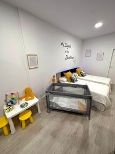 a bedroom with a bed and a table and a bed and a bed at Luxury La Restinga in La Restinga
