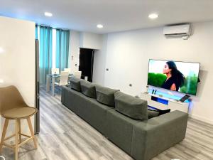 a living room with a couch and a flat screen tv at Luxury La Restinga in La Restinga