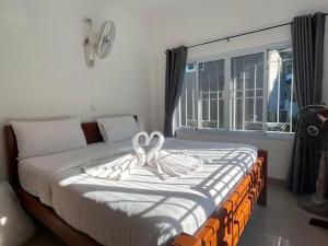 a bedroom with a bed with a heart decoration on it at SuanMalisamuiVilla G01 in Koh Samui