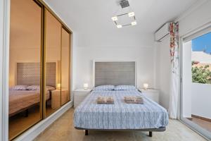 a bedroom with a bed and a large window at Villa Montelimar - Biznaga Rental Homes in Rincón de la Victoria