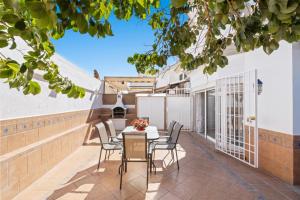a patio with a table and chairs on a balcony at Villa Montelimar - Biznaga Rental Homes in Rincón de la Victoria