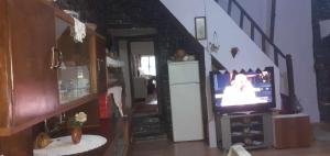 a living room with a staircase with a television at guest house in buhal in Përmet