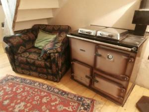 a living room with a couch and a stove at Threecrofts Farm in Dumfries