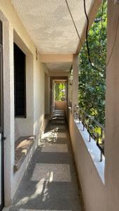 a hallway with benches on the side of a building at Hotel Bigu in Puerto Escondido