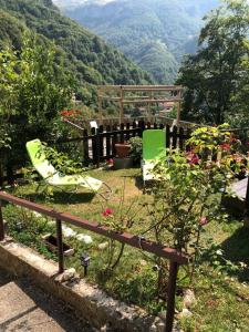 a bench in a garden with a view of a mountain at Haus Granata Family - Trekking - Bike in Giazza