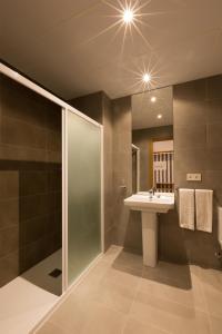 a bathroom with a sink and a shower at IRAIPE Pamplona Hostal in Pamplona