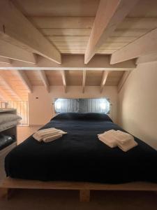 a large bed with two towels on top of it at Incanto Glamping village in Savio di Ravenna